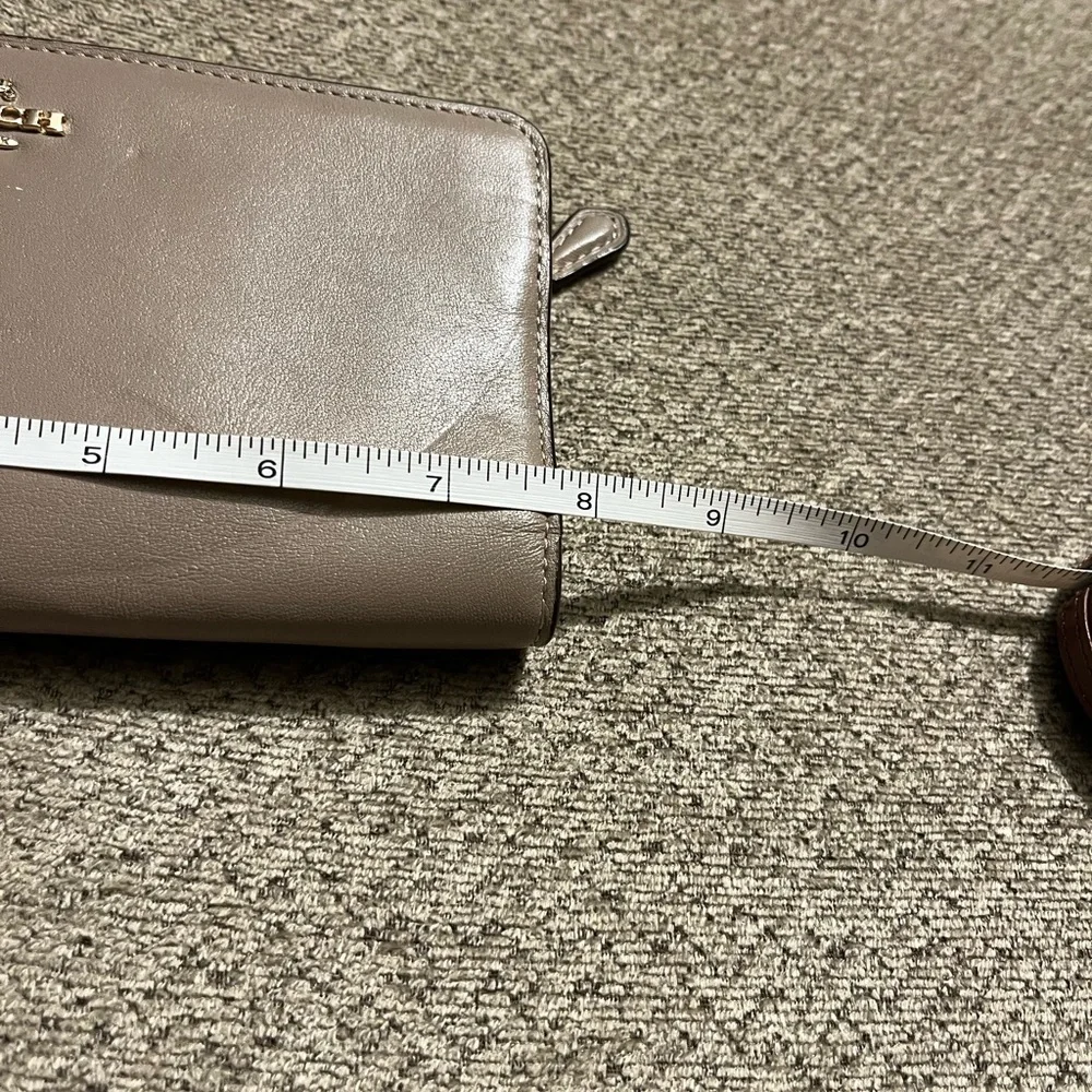 Coach wallet. Has some wear marks and wrinkles on outside of wallet.